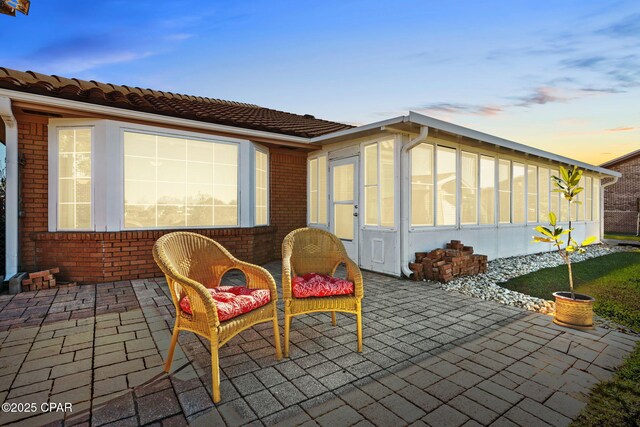 patio terrace at dusk with a sunroom