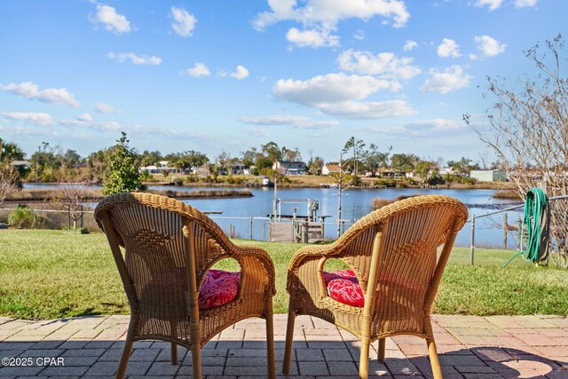 view of patio / terrace with a boat dock and a water view