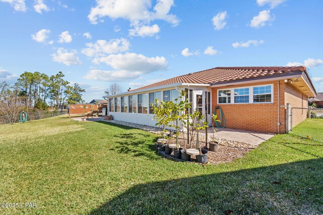 back of property featuring a yard and a patio area