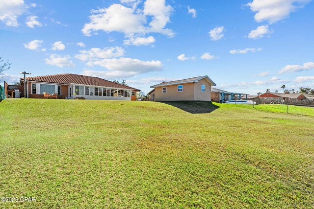 view of yard featuring a sunroom