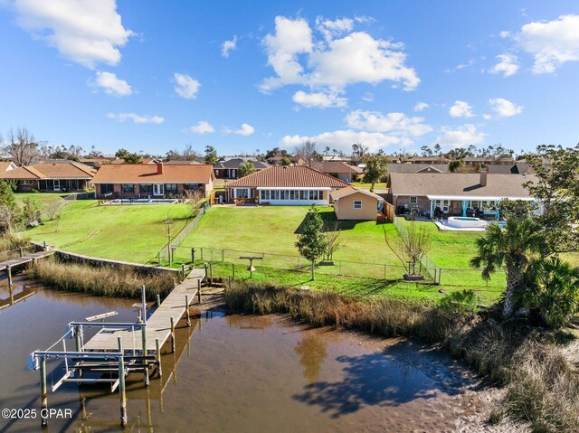 view of dock featuring a yard and a water view