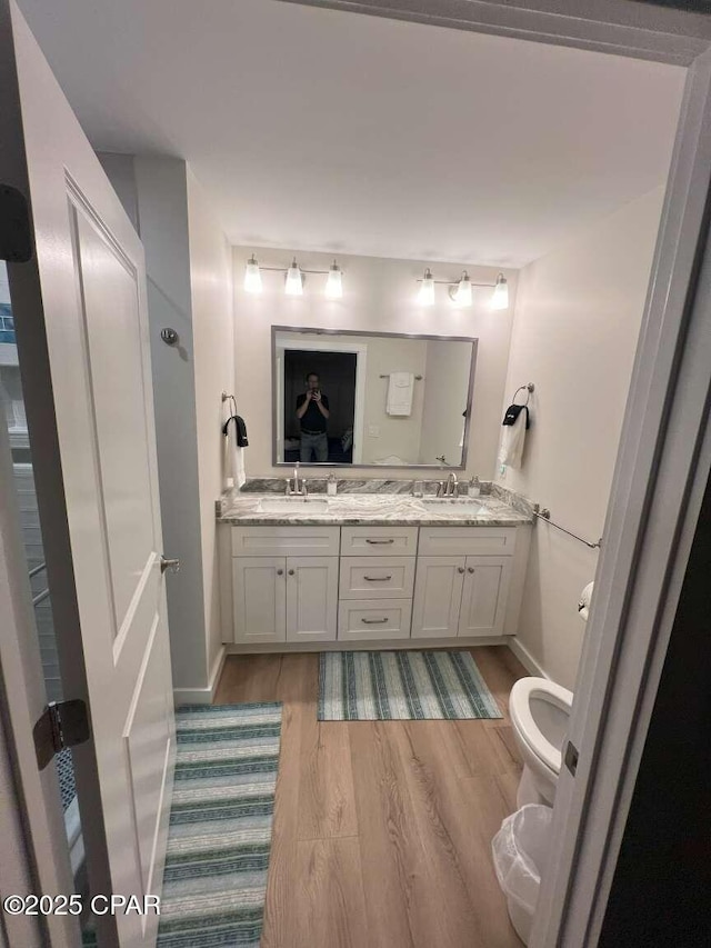 145 Turtle Walk Unit 60, Port St Joe, FL 32456 - bathroom featuring toilet, double vanity, wood finished floors, and baseboards