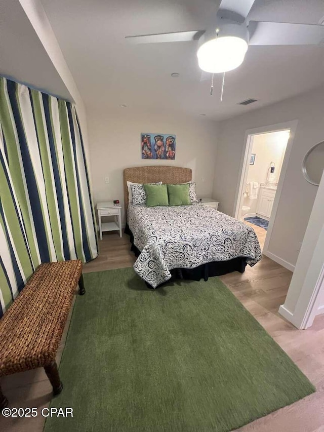 145 Turtle Walk Unit 60, Port St Joe, FL 32456 - bedroom featuring wood finished floors, ensuite bath, and a ceiling fan