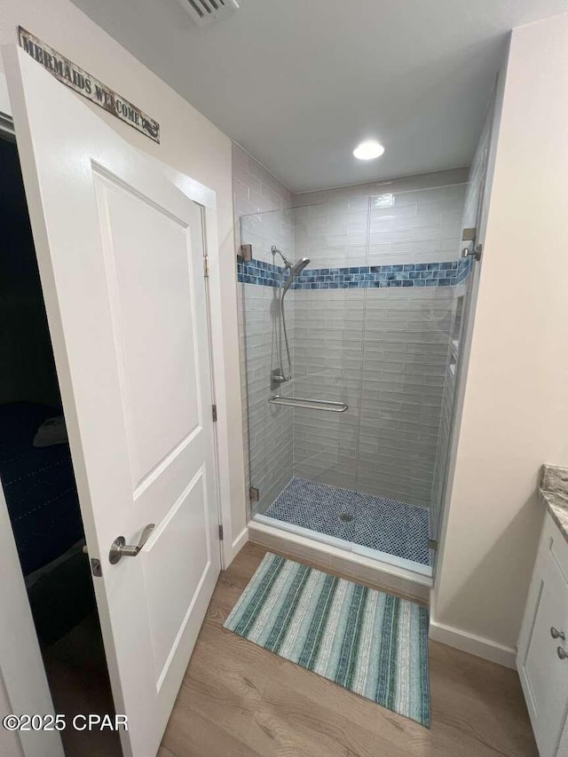 145 Turtle Walk Unit 60, Port St Joe, FL 32456 - bathroom with a stall shower, baseboards, vanity, recessed lighting, and wood finished floors