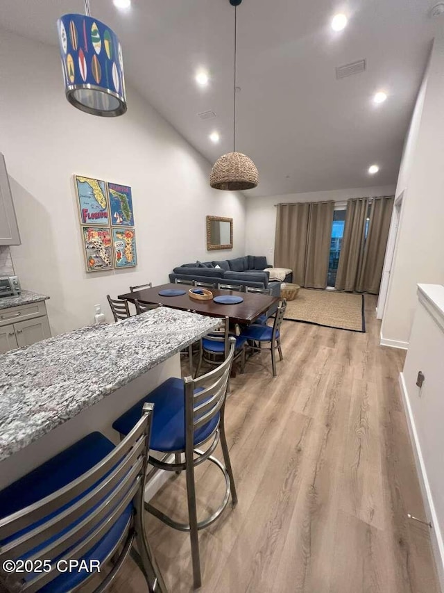 145 Turtle Walk Unit 60, Port St Joe, FL 32456 - dining area featuring light wood-style flooring, recessed lighting, and vaulted ceiling
