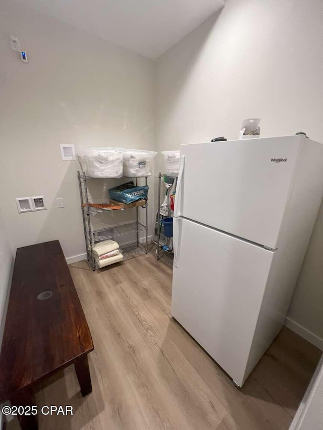 145 Turtle Walk Unit 60, Port St Joe, FL 32456 - kitchen with freestanding refrigerator, wood finished floors, and baseboards
