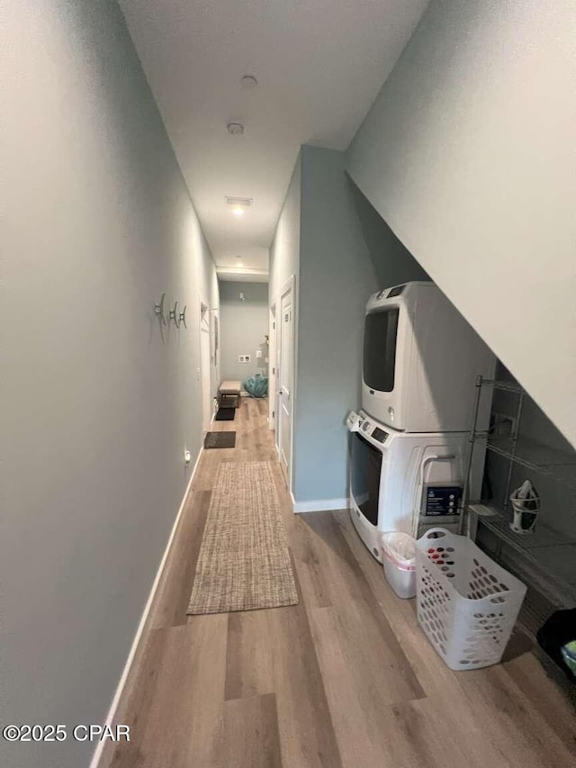 145 Turtle Walk Unit 60, Port St Joe, FL 32456 - hallway with stacked washer / drying machine, wood finished floors, and baseboards