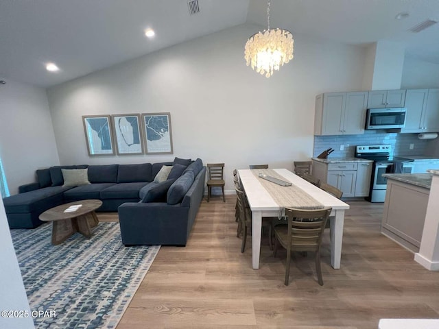 145 Turtle Walk Unit 60, Port St Joe, FL 32456 - living area featuring a chandelier, high vaulted ceiling, light wood-type flooring, recessed lighting, and baseboards