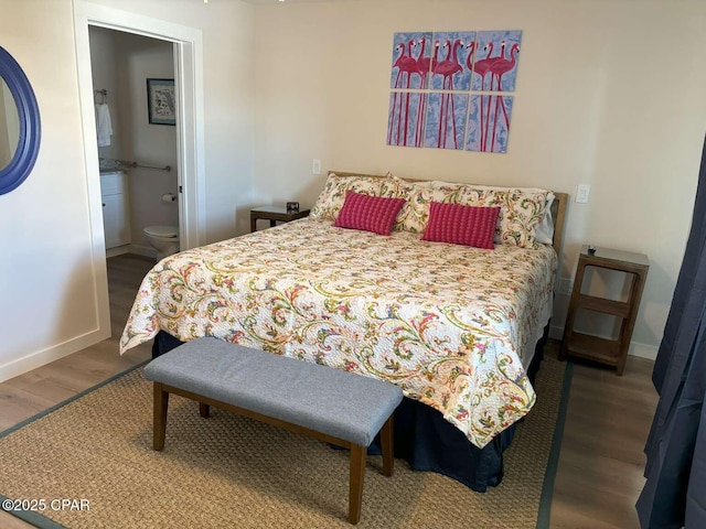 145 Turtle Walk Unit 60, Port St Joe, FL 32456 - bedroom featuring wood finished floors, baseboards, and connected bathroom