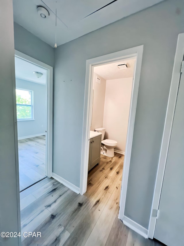 1730 Mallard Dr Apt F, Panama City, FL 32404 - bathroom with toilet, vanity, wood finished floors, baseboards, and visible vents