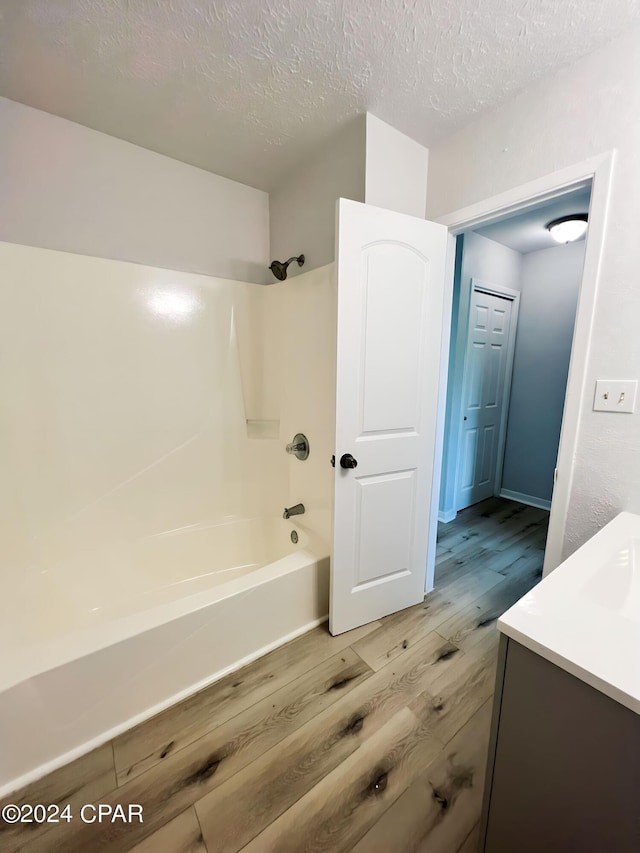 1730 Mallard Dr Apt F, Panama City, FL 32404 - bathroom with a textured ceiling, wood finished floors, vanity, and shower / washtub combination