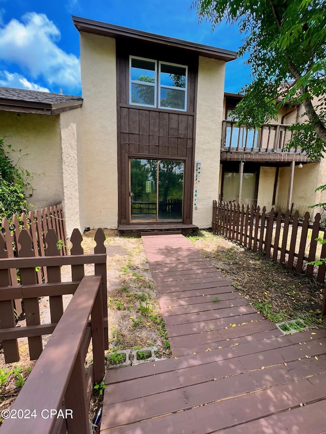 1730 Mallard Dr Apt F, Panama City, FL 32404 - entrance to property with stucco siding, a wooden deck, and fence