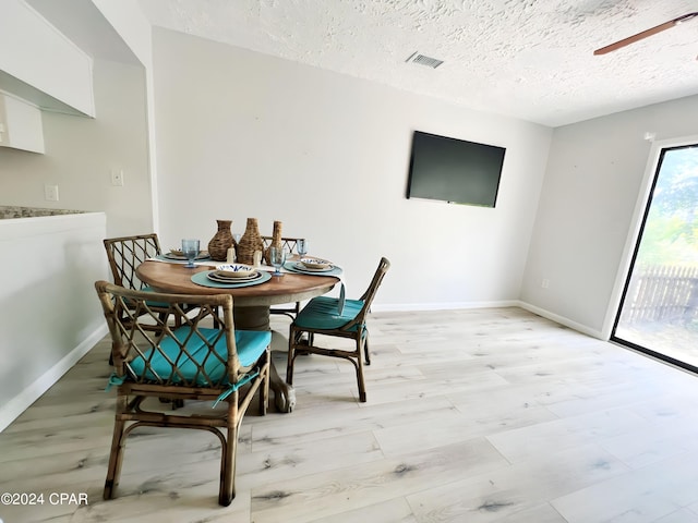 1730 Mallard Dr Apt F, Panama City, FL 32404 - dining room featuring a textured ceiling, visible vents, light wood-style floors, and ceiling fan