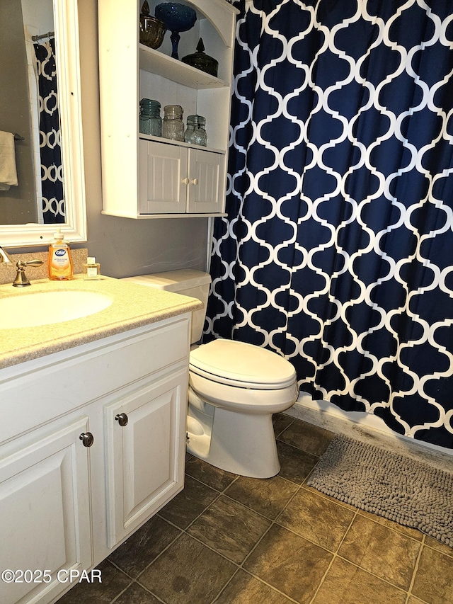 bathroom featuring vanity and toilet