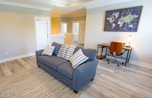 living room with light hardwood / wood-style floors and ornamental molding