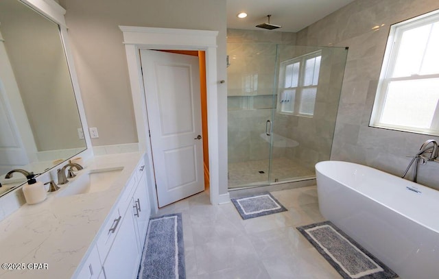 bathroom featuring tile patterned floors, vanity, and independent shower and bath