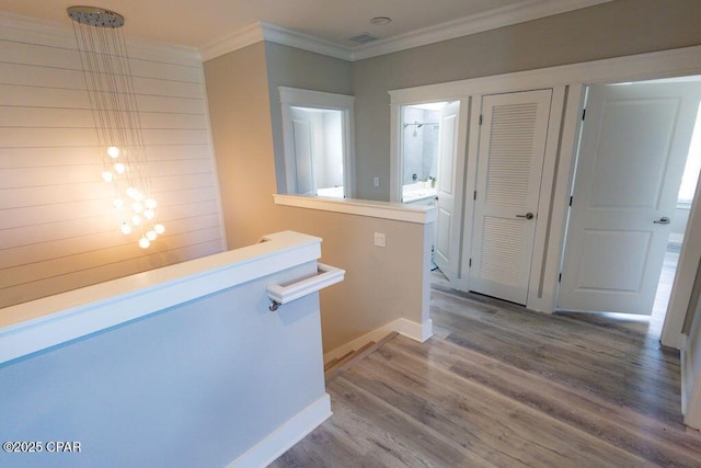 hall featuring hardwood / wood-style flooring and crown molding