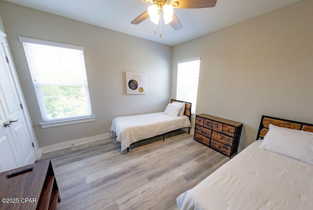 bedroom with ceiling fan and light hardwood / wood-style flooring