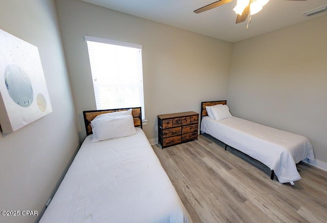 bedroom featuring light hardwood / wood-style floors and ceiling fan