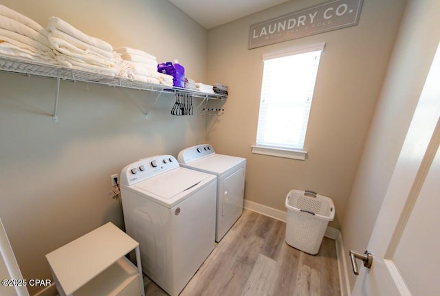 laundry area featuring light hardwood / wood-style floors and independent washer and dryer