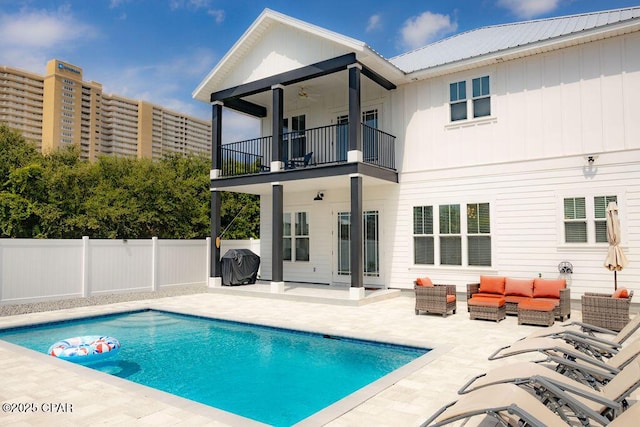 back of house featuring an outdoor hangout area, a balcony, ceiling fan, a patio, and a fenced in pool