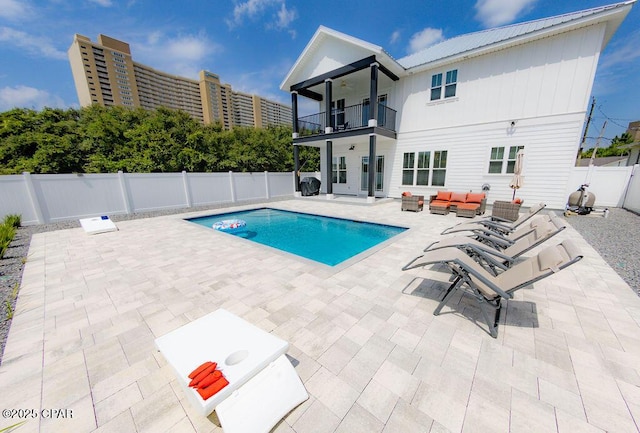 view of pool with an outdoor hangout area, ceiling fan, and a patio area