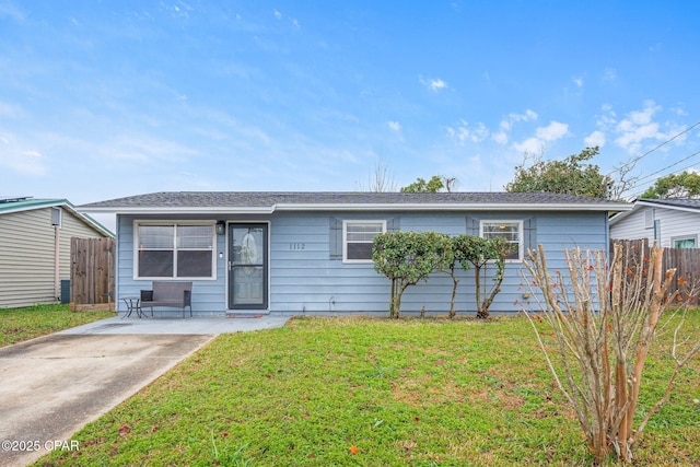 single story home featuring a front lawn and fence