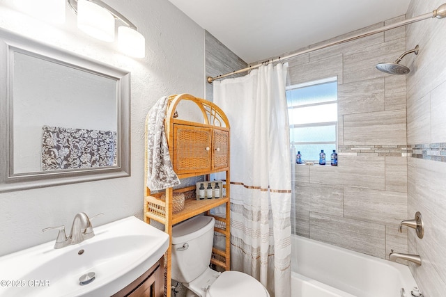 full bath with toilet, vanity, a textured wall, and shower / bathtub combination with curtain