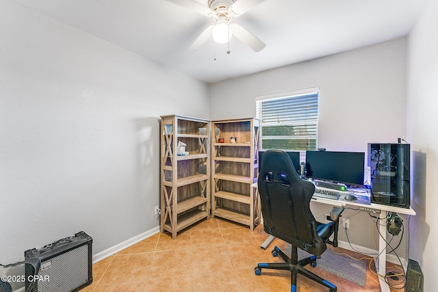 tiled office with a ceiling fan and baseboards