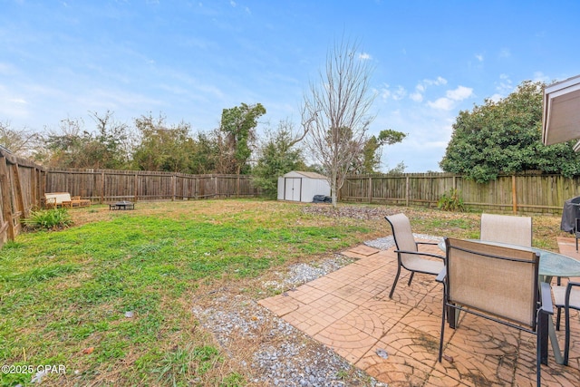 view of yard with a fenced backyard, outdoor dining area, a storage shed, and an outdoor structure