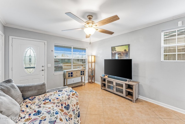 living area with crown molding, light tile patterned flooring, baseboards, and ceiling fan