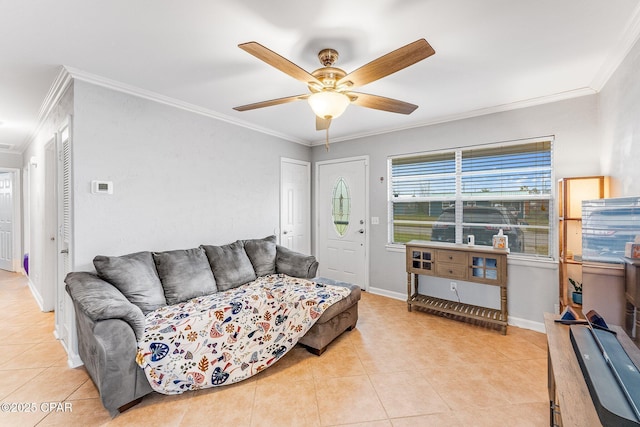 living room featuring light tile patterned floors, a ceiling fan, crown molding, and baseboards