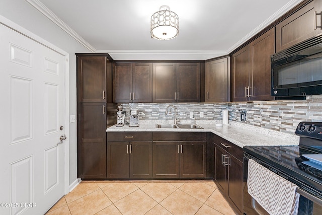 kitchen featuring black appliances, light tile patterned floors, dark brown cabinets, and a sink