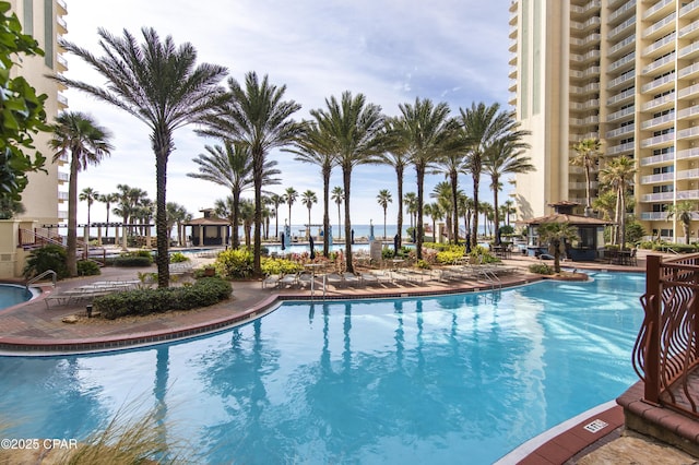 view of swimming pool featuring a water view