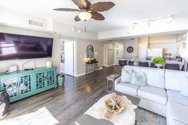 living room with ceiling fan and dark hardwood / wood-style flooring