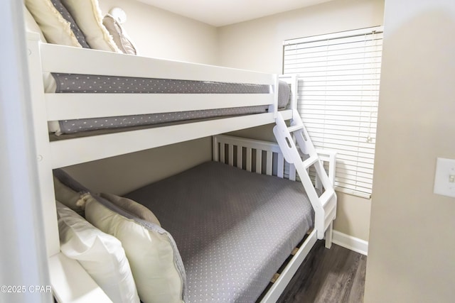 bedroom with dark hardwood / wood-style flooring