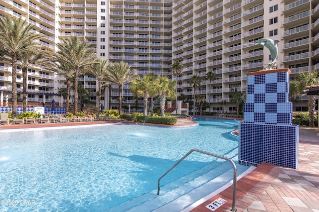 view of swimming pool with pool water feature