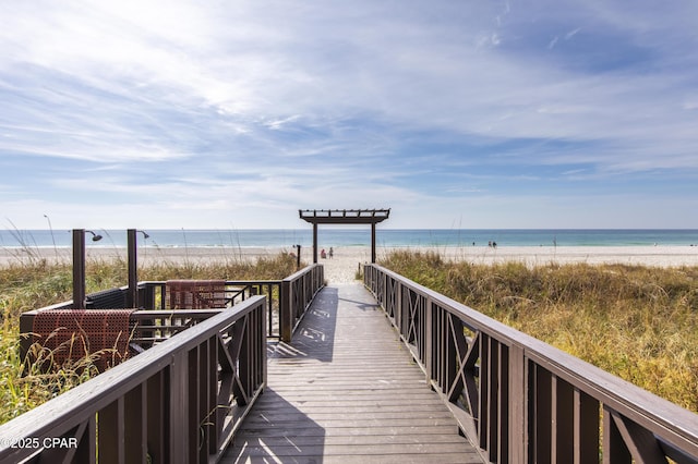 surrounding community featuring a water view and a beach view