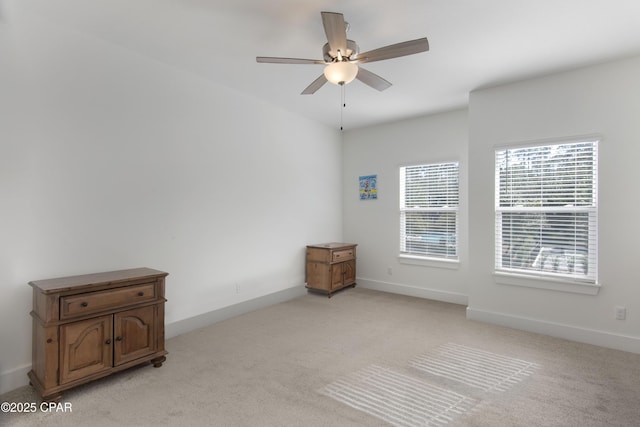 unfurnished room with light carpet and ceiling fan