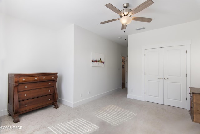 carpeted bedroom featuring a closet and ceiling fan