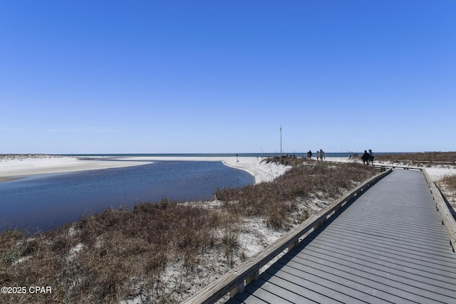 dock area with a water view and a view of the beach