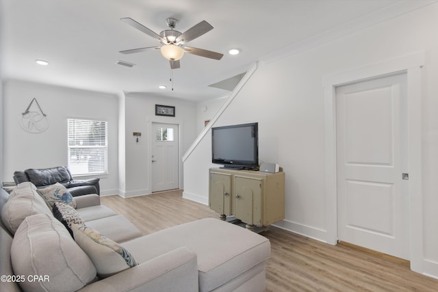 living room featuring light wood-type flooring and ceiling fan