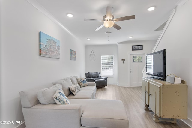 living room featuring light wood-type flooring and ceiling fan