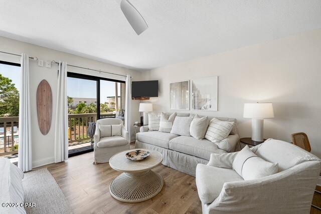 living room with plenty of natural light and hardwood / wood-style flooring