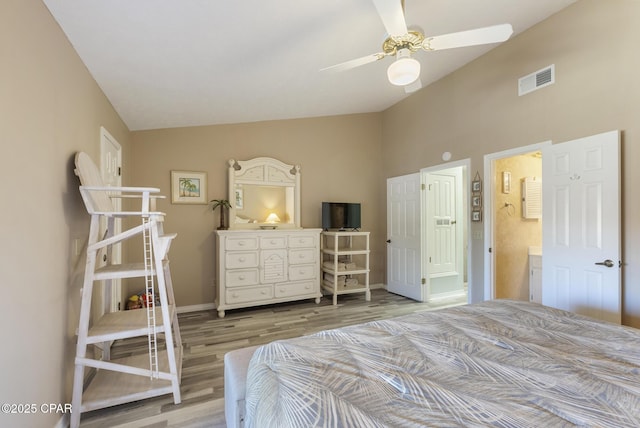 bedroom with visible vents, light wood finished floors, baseboards, ceiling fan, and vaulted ceiling