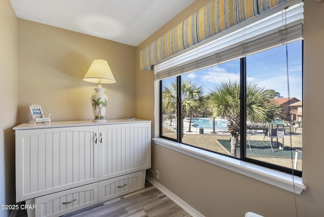 interior space featuring wood finished floors and baseboards