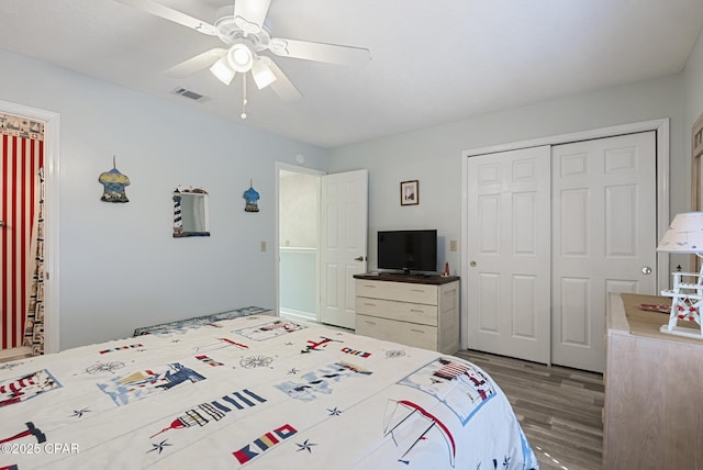 bedroom featuring a closet, visible vents, ceiling fan, and wood finished floors