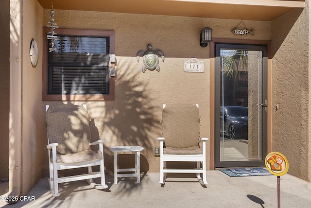 entrance to property with stucco siding