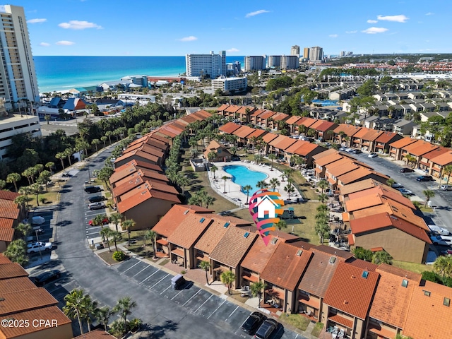 birds eye view of property with a water view and a city view