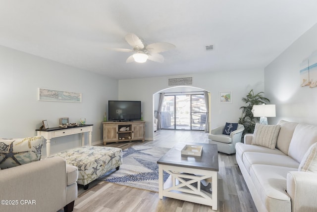 living area featuring ceiling fan, visible vents, and wood finished floors